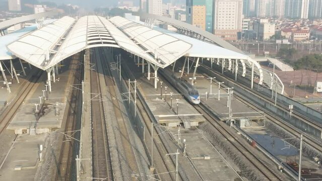 a high-speed train departing from a station,  KTX train in Korea, Osong station