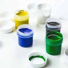 Gouache Paint cans on a white background. copy space