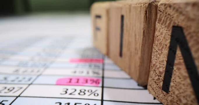 Word finance on wooden cubes on table with numbers closeup 4k movie