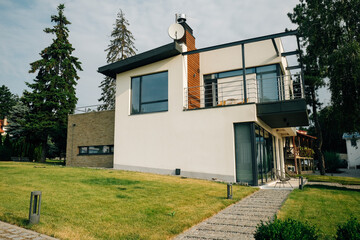 View of a cozy modern two-story country cottage.