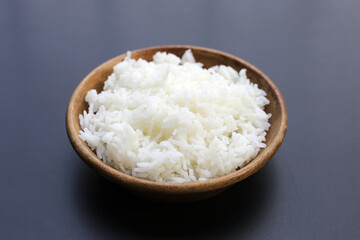 Cooked rice on dark background.