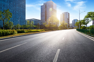 Empty asphalt road near office buildings