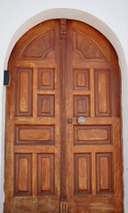 Old fashioned front door entrance, white facade and brown door, Rhodos, Greece