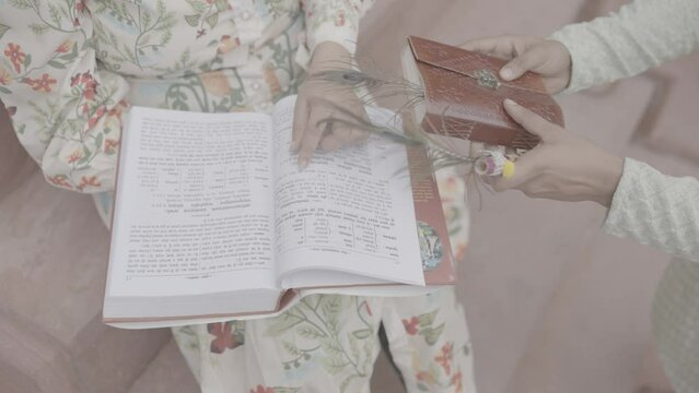 In the quiet embrace of knowledge, an Indian girl finds joy as she reads a book, unlocking the wonders of imagination and learning.4k footage 