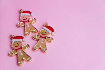 Christmas decorations gingerbread man and lollipops on pink background