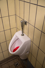 Urinal commonly seen in a mens room. 