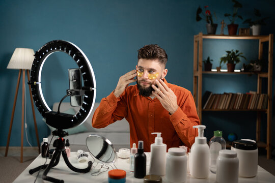 Bearded man beauty vlogger. Video by smartphone sharing on social media. Male blogger make-up artist or cosmetologist live. Recording skin care routine tutorial.