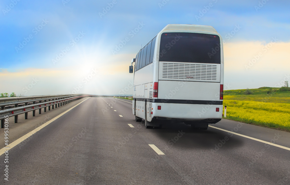 Sticker tourist bus moves along a country highway