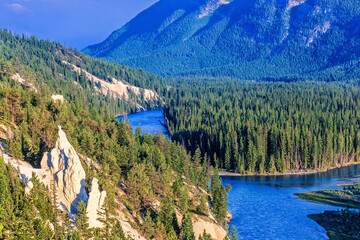River in a coniferous forest with som hoodoos