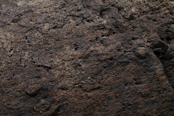 Brown stone texture, dark abstract background. Natural mineral rock close up details, empty backdrop with copy space for design