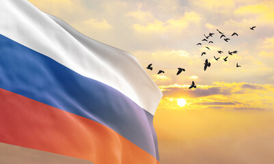 Waving flag of Russia against the background of a sunset or sunrise. Russia flag for Independence Day. The symbol of the state on wavy fabric. - obrazy, fototapety, plakaty