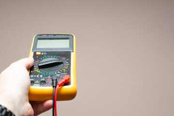 multimeter in a man's hand