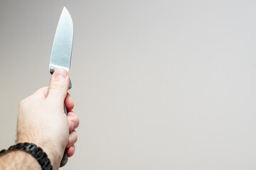 man's hand holding a folding knife