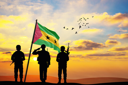 Silhouettes of soldiers with the São Tomé and Príncipe flag stand against the background of a sunset or sunrise. Concept of national holidays. Commemoration Day.