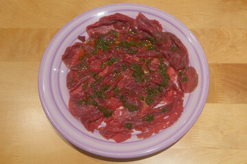 Carpaccio with oil and basil