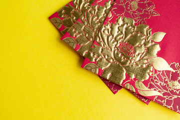 Chinese New Year red packets on yellow cover background with customizable space for text