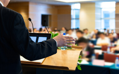 Business man making a speech in front of big audience