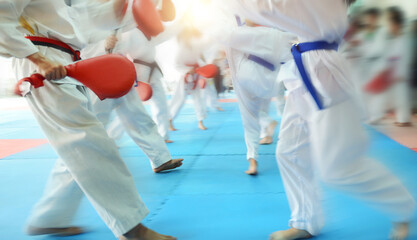 People in martial arts training exercising taekwondo with blur motion