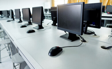 Row of computers neatly placed in computer lab