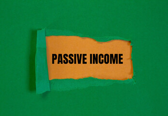 Passive income lettering on ripped paper. Business concept photo.