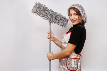 A beautiful girl holds a mop in her hands. Housework concept.