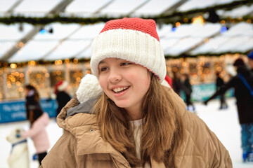 Fun on a winter Christmas skating rink, Portrait of a 11-13 year old girl skating