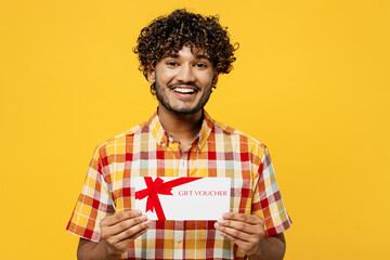 Young smiling happy cheerful Indian man he wears shirt casual clothes hold gift certificate coupon...