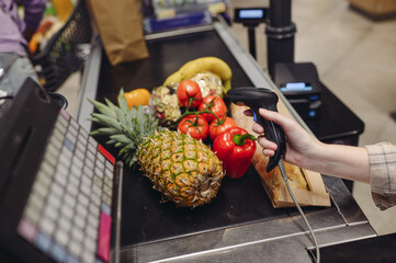 Cropped close up customer woman scan fruit on self-service cash register shopping at supermaket...