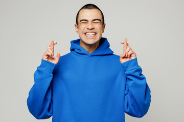 Young worried middle eastern man wear blue hoody casual clothes waiting for special moment, keeping...