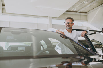 Adult rich man customer male buyer client he wear shirt open door get into car look aside choose...