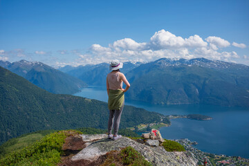 Hikers climb to the summit of Raudmelen peak which overlookis the town of Balestrand on Sognefjord...