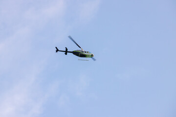 Helicopeter is in hlue sky on a sunny day