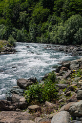 Obraz premium Streams of water from a mountain river, pouring, bubbling and waves of water close-up