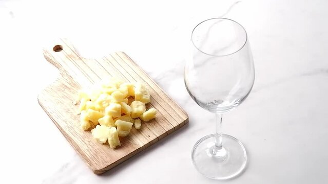 Pouring red wine and delisious cheese on the table