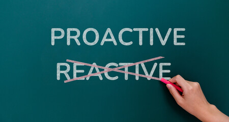 Hand writing proactive and reactive on blackboard