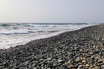 Stony part of the beach between Playa del Ingles and Maspalomas, Gran Canary, Spain.