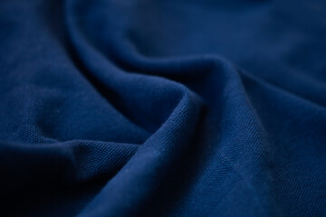 dark blue - abstract fabric background with soft waves.
