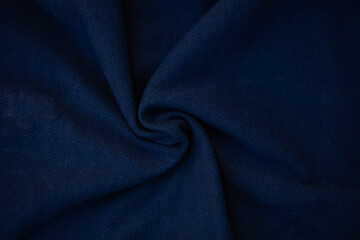 dark blue - abstract fabric background with soft waves.