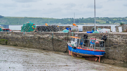 A harbor at low tide with fishing boats anchored. Copy space for text.