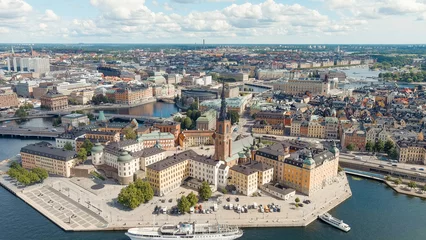 Foto auf Acrylglas Stockholm, Sweden. Island Riddarholmen and Lake Malaren. Riddarholmen Church. Panorama of the city. Summer day, Aerial View © nikitamaykov