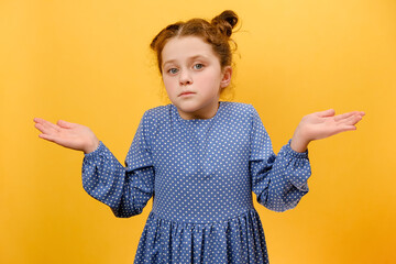 Portrait of confused preteen girl child spread palms aside and shrugging shoulders, saying sorry,...