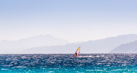 one surfer rides on a background of high mountains in Egypt Dahab South Sinai
