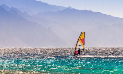 windsurfer rides on a background of high mountains in Egypt Dahab South Sinai