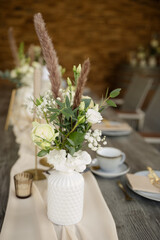 Frische Hochzeitsblumen mit Eukalyptus für eine elegante Hochzeitstafel