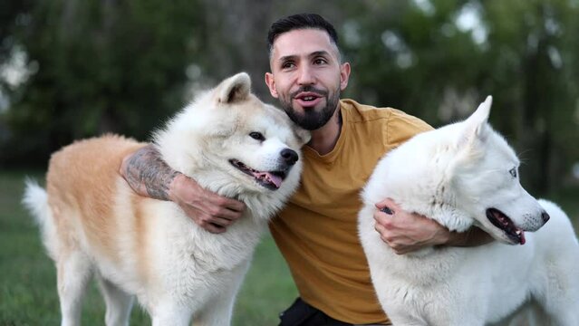 man enjoying with his dogs in the park