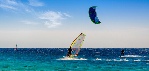windsurfers and kitesurfers ride in the Red Sea in Egypt Sharm El Sheikh