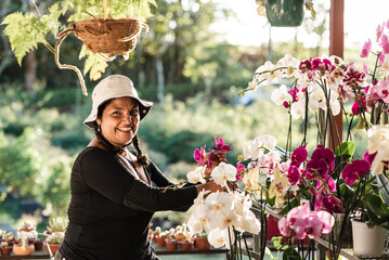 Happy woman arranging her flower garden