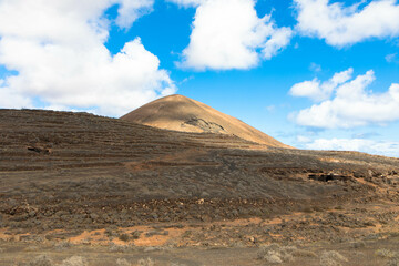 Spectacular view of the volcanic landscape in Timanfaya National Park. Lanzarote, Canary Islands, Spain, Atlantic, Europe. Tourism and vacations concept.