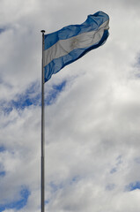 Argentine flag flying in the sky, worn flag