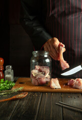 The cook cuts the carp to prepare the herring in a jar with spices and salt. Concept of salting...